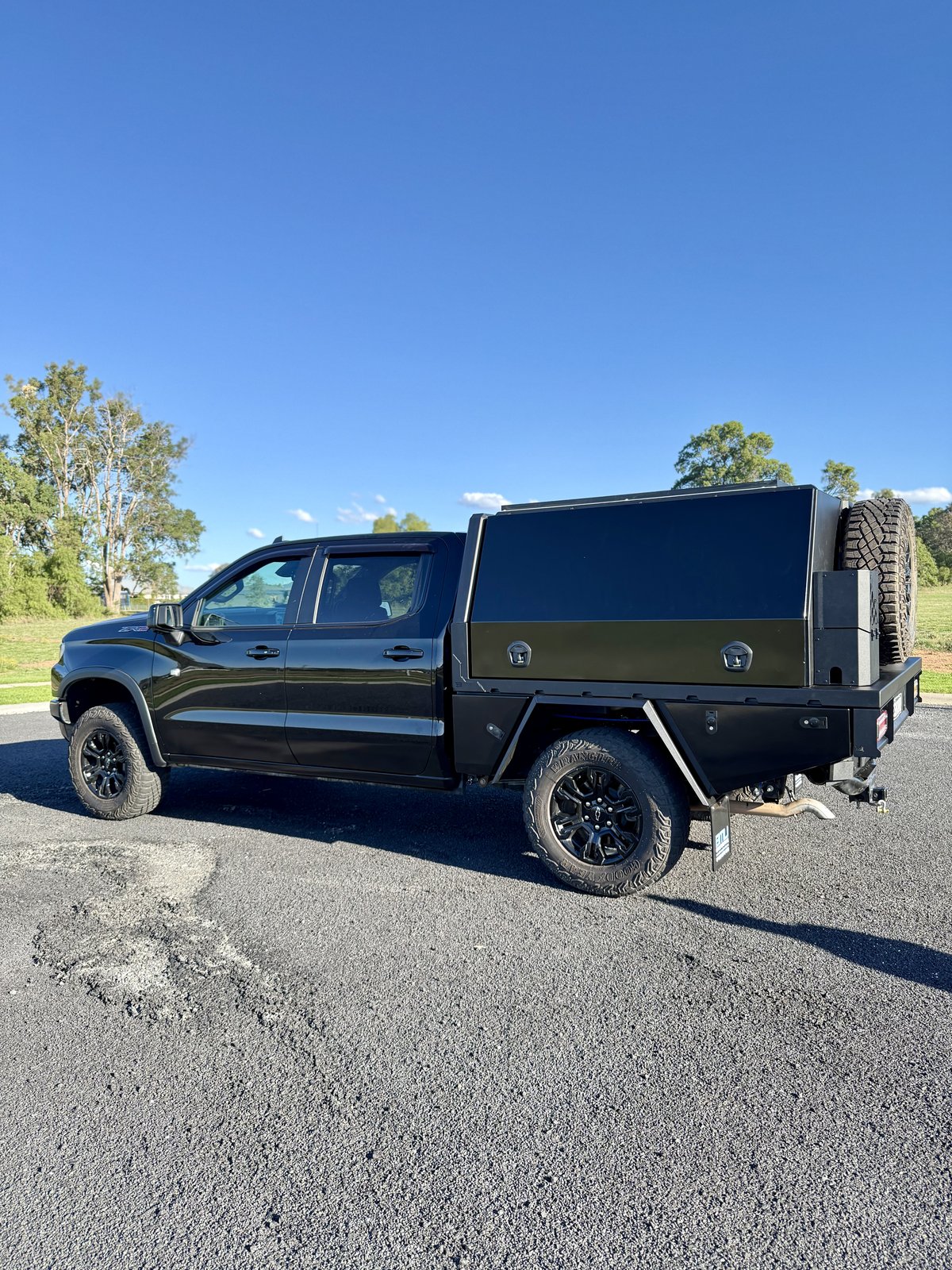 Chevrolet Silverado side profile with BMU tray and canopy touring build, spare wheel mounted